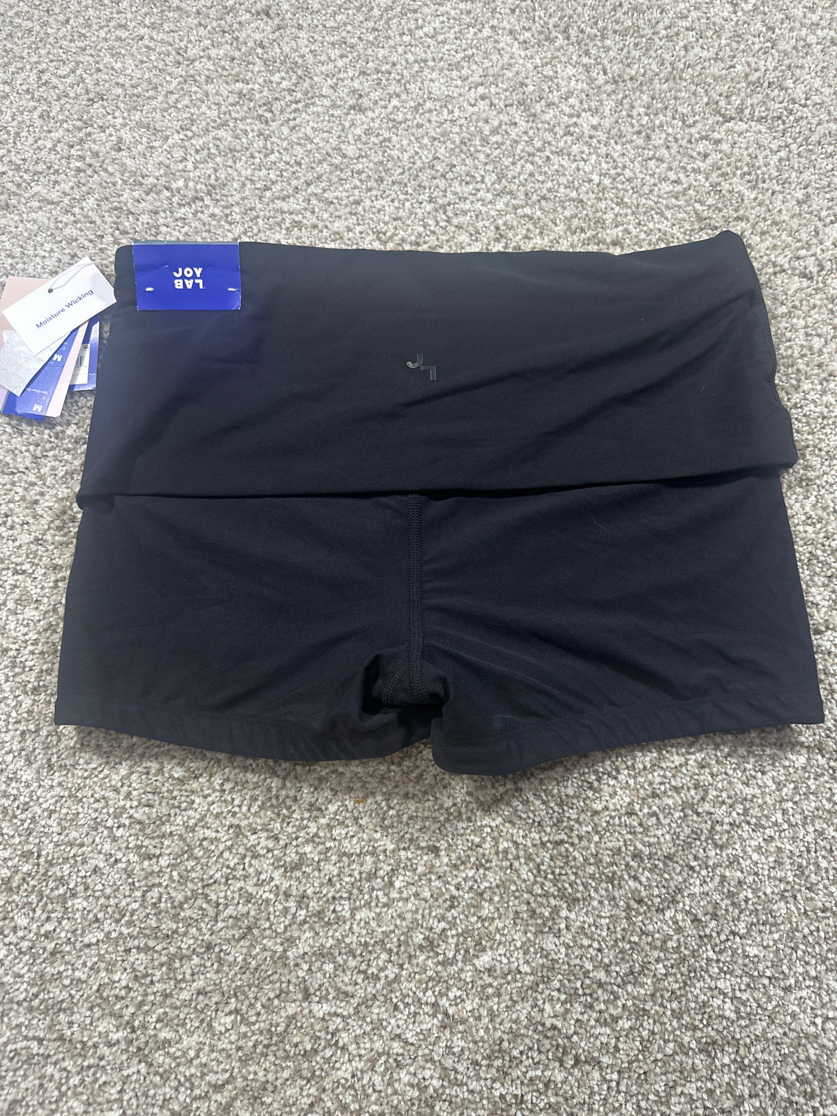 JoyLab black low-rise built-in shorts back view with moisture-wicking tag
