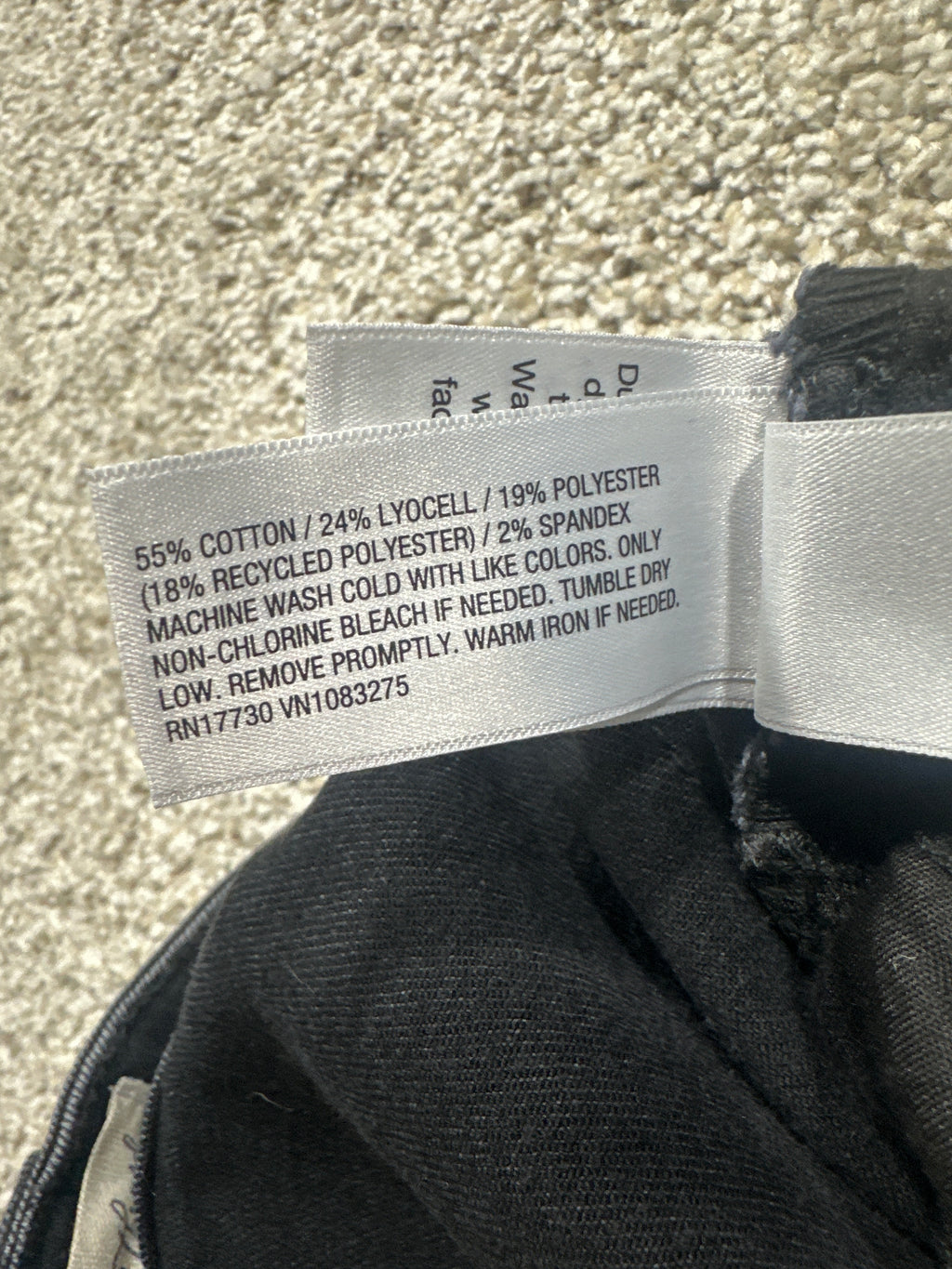 Universal Thread jeans material label showing cotton, lyocell, recycled polyester, and spandex