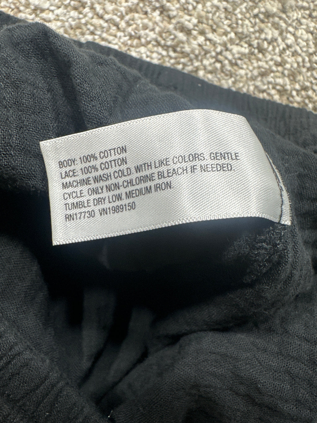 Universal Thread cotton pants material label showing 100 percent cotton body and lace
