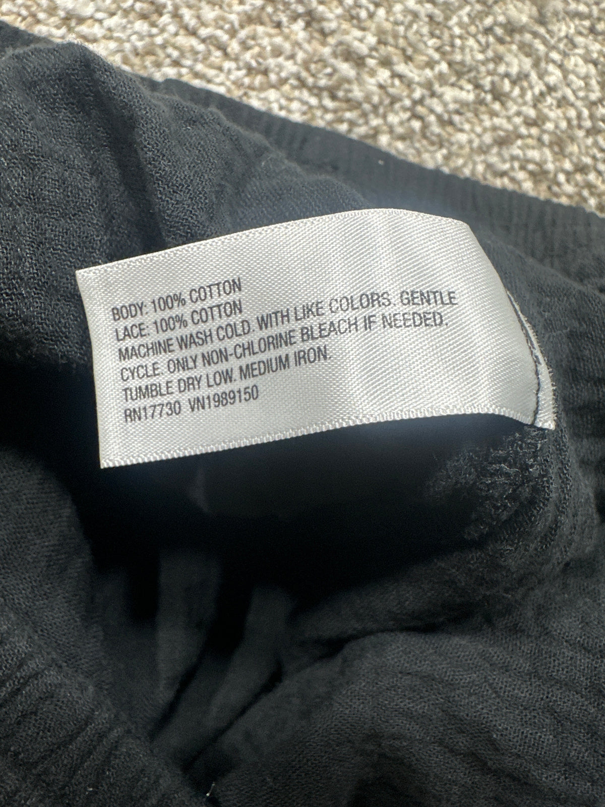 Universal Thread cotton pants material label showing 100 percent cotton body and lace