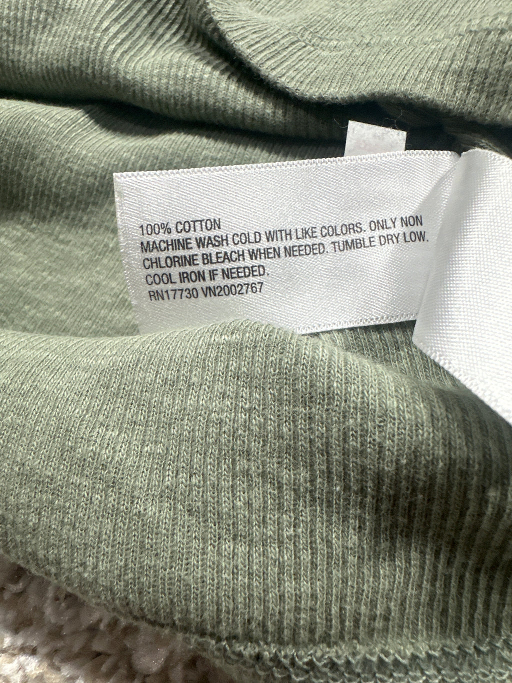 Universal Thread T-shirt material label showing 100 percent cotton