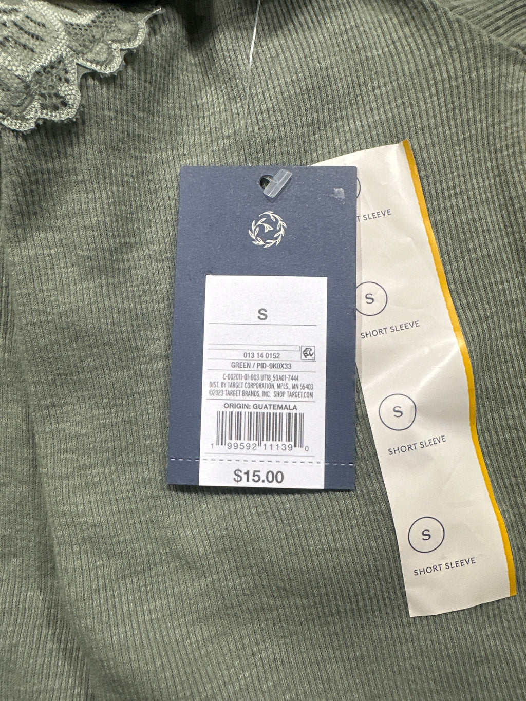 Universal Thread green T-shirt retail tag showing size S and UPC