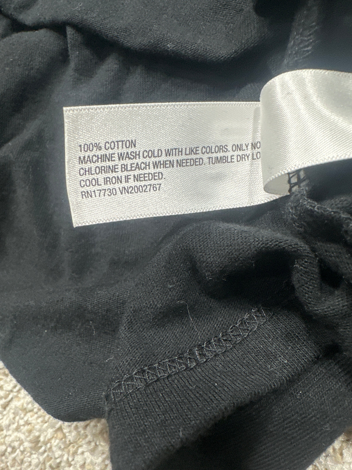 Universal Thread T-shirt material label showing 100 percent cotton