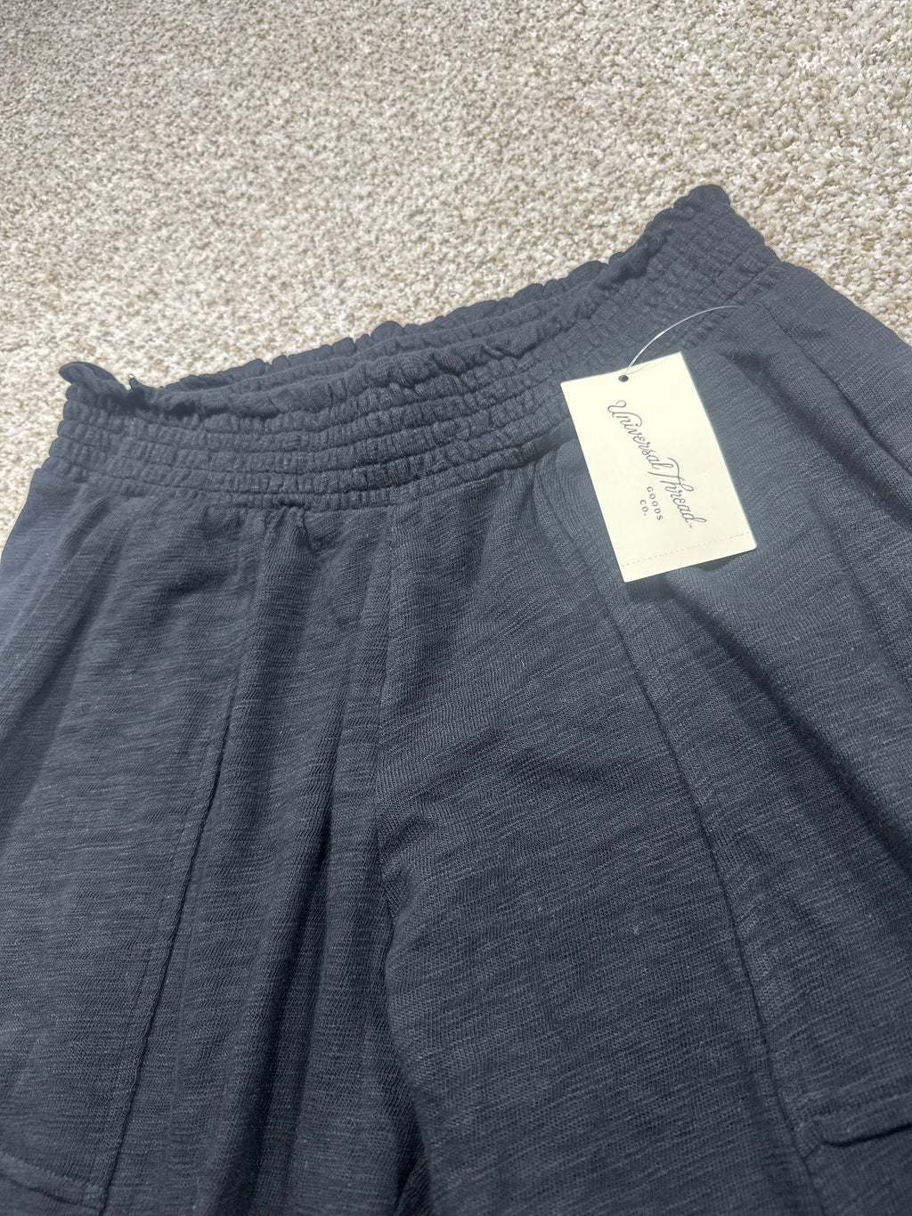 Universal Thread black pants waistband and front pockets detail