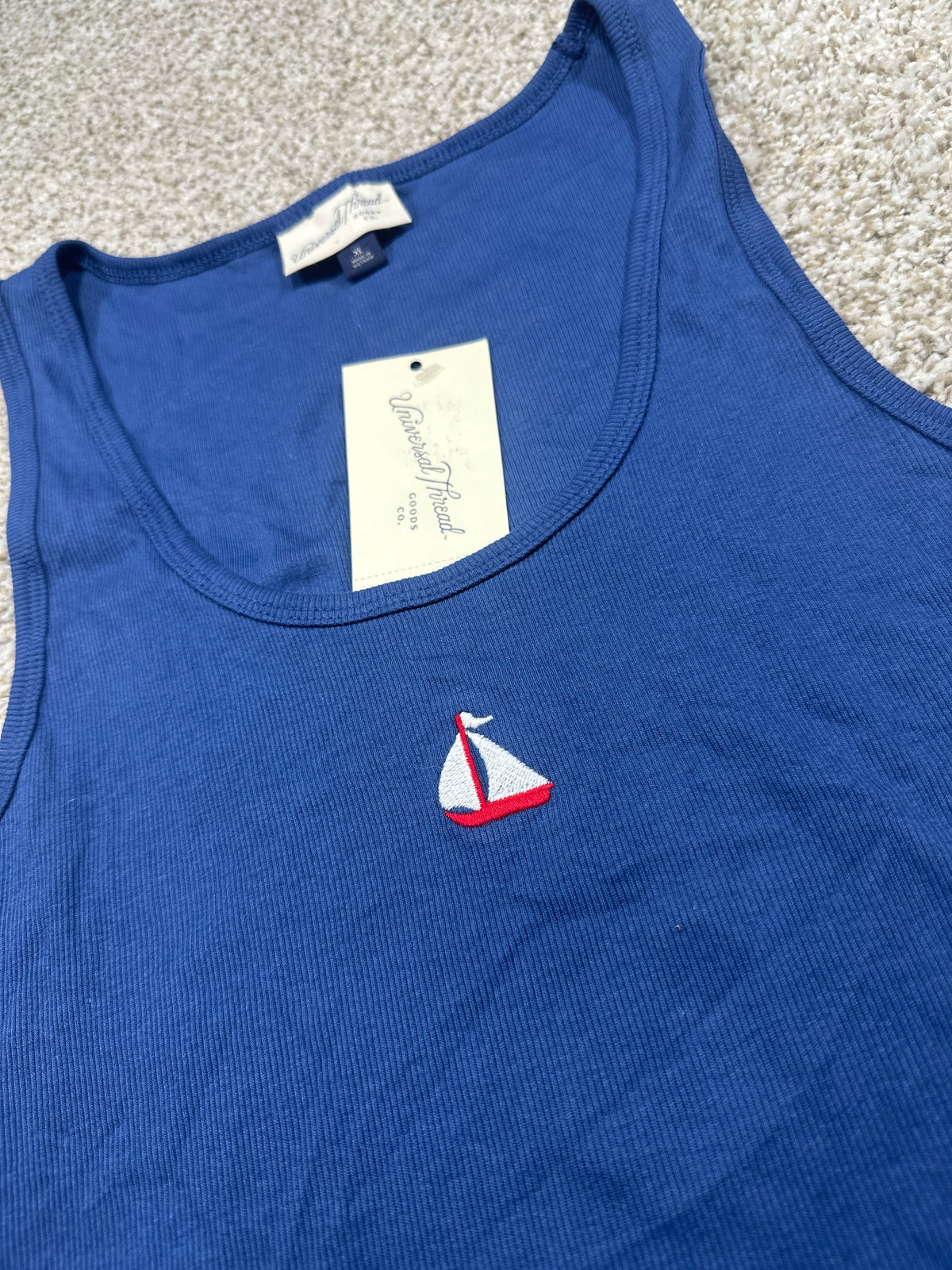 Universal Thread navy tank top neckline and embroidered sailboat detail