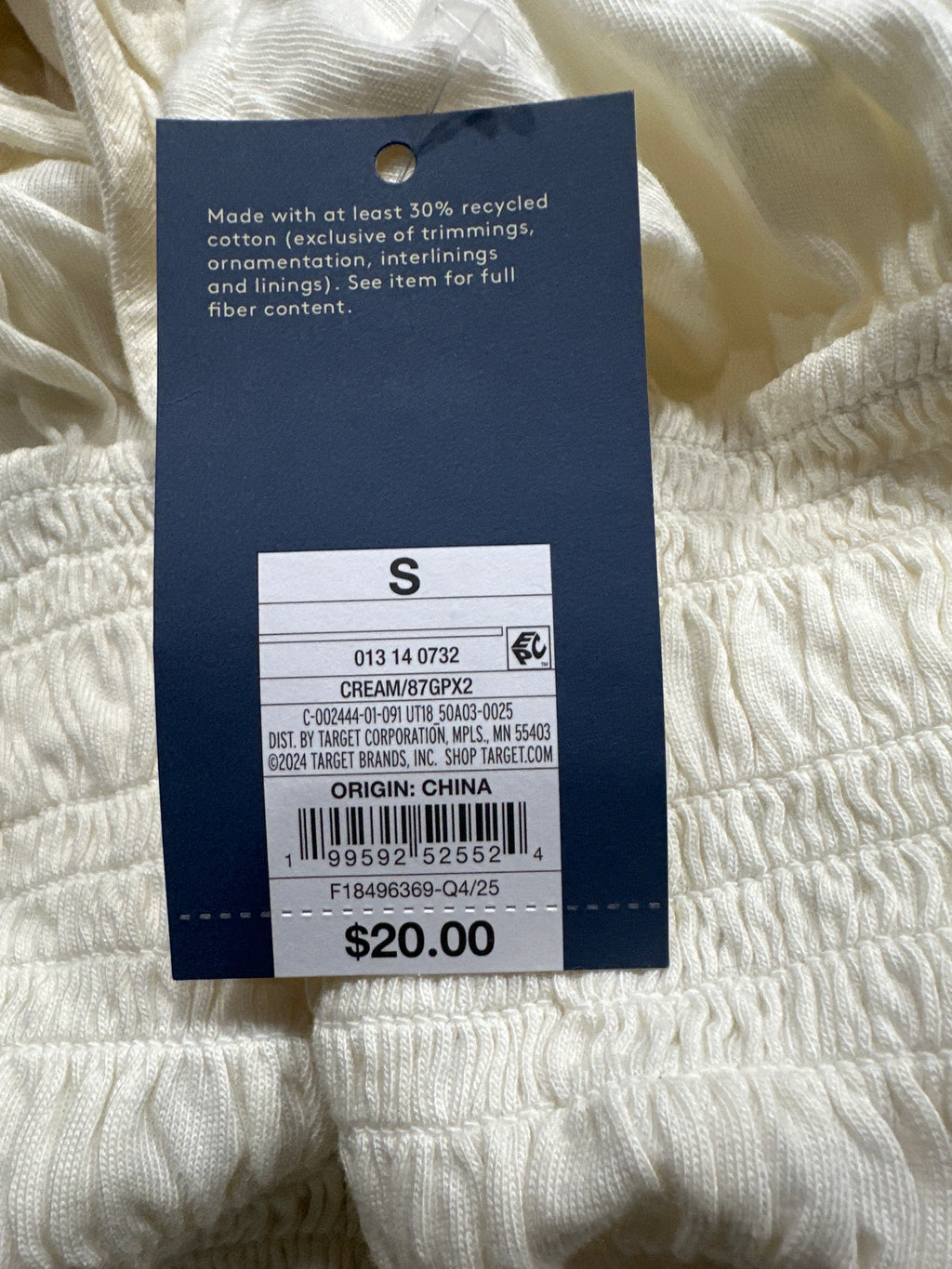 Universal Thread women's cream smocked puff sleeve top barcode and size tag