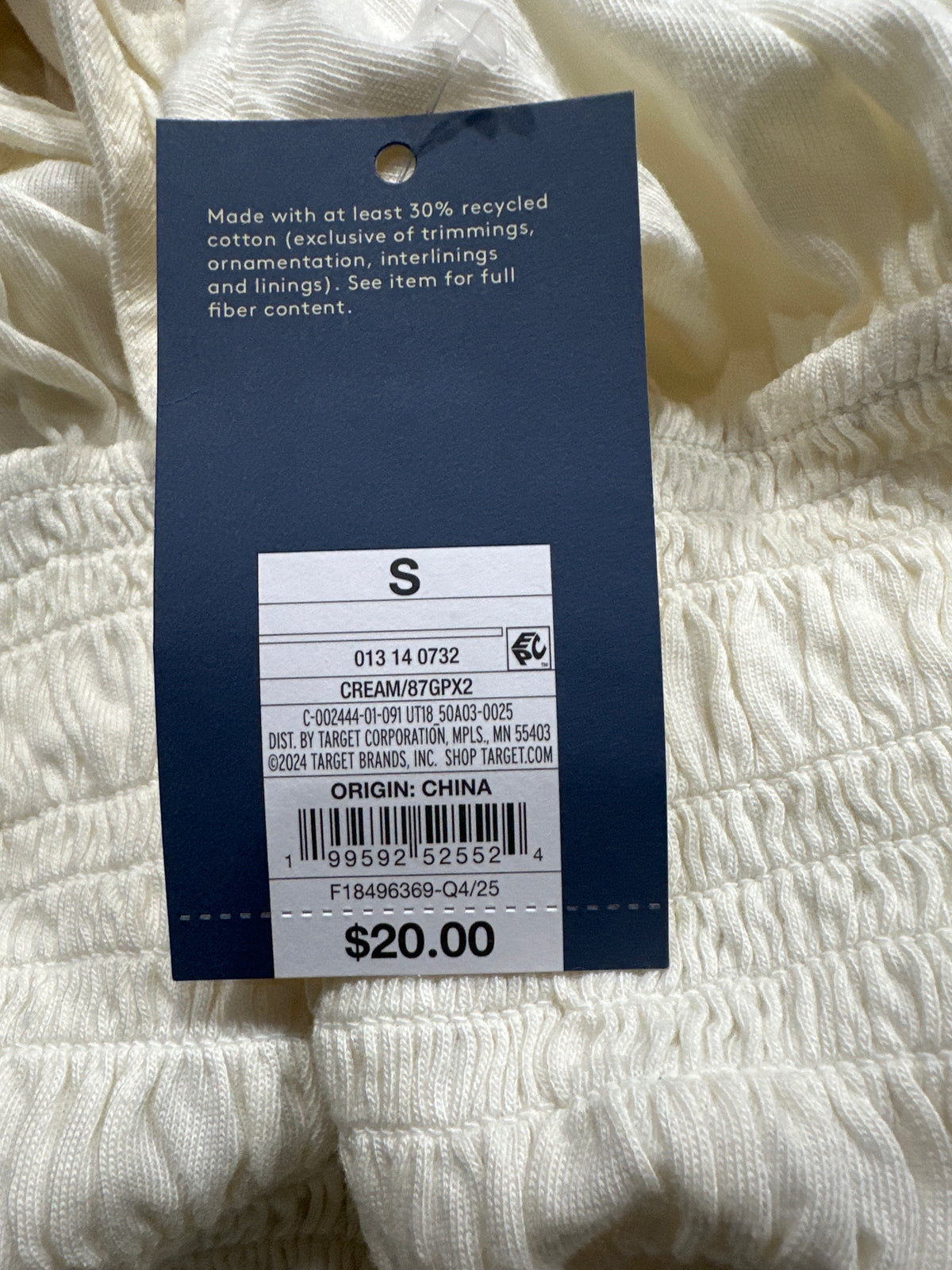 Universal Thread women's cream smocked puff sleeve top barcode and size tag