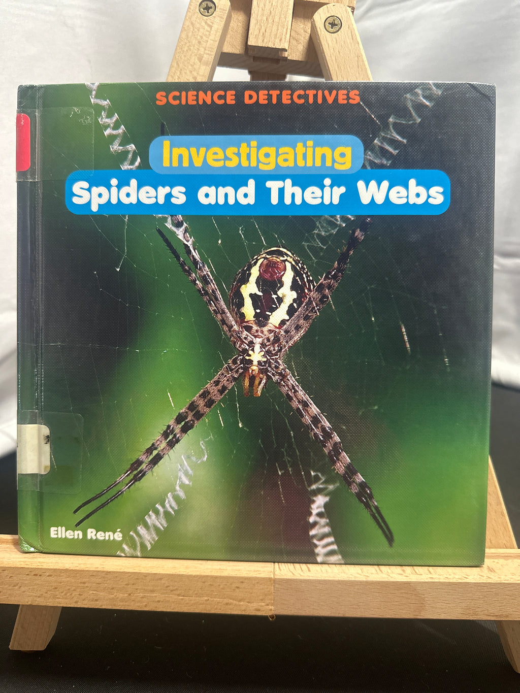 Investigating spiders and their webs by Ellen René Hardcover Children's Book