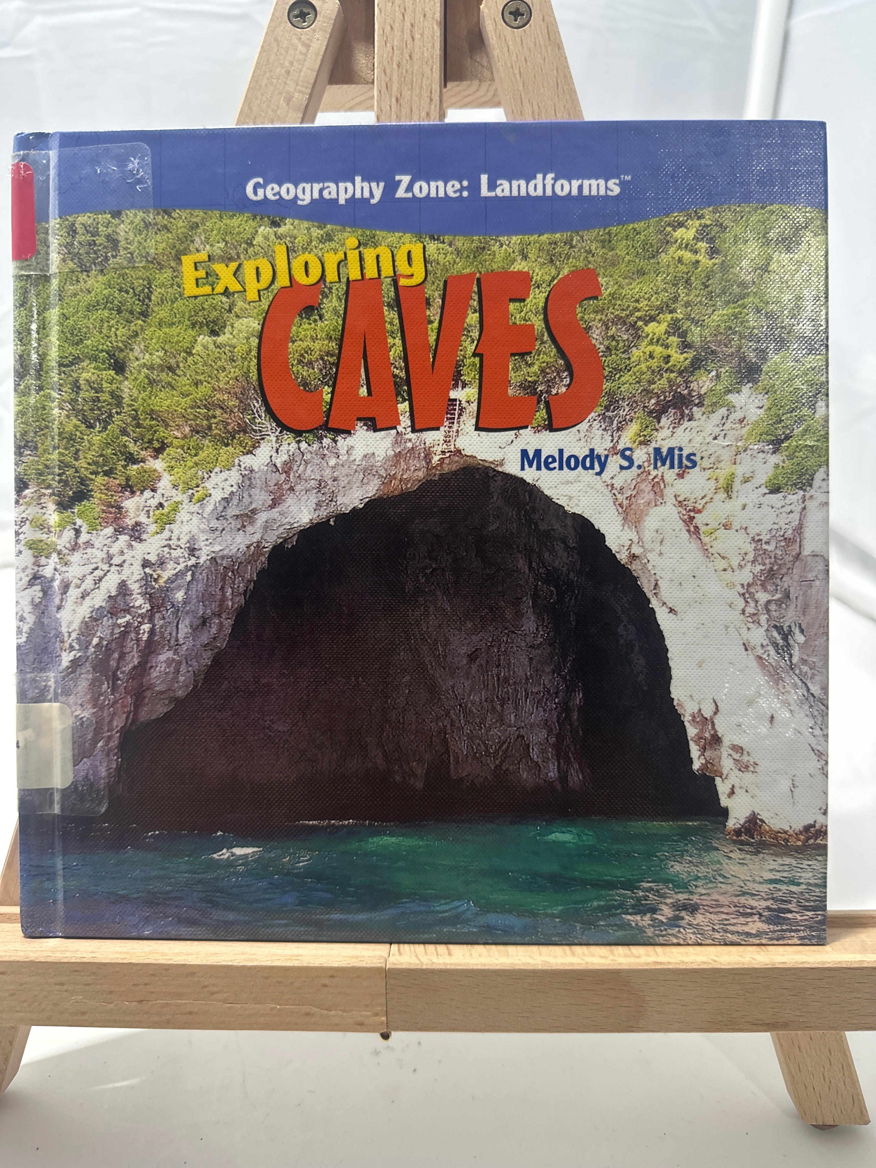 Exploring caves by Melody S. Mis Hardcover Children's Book