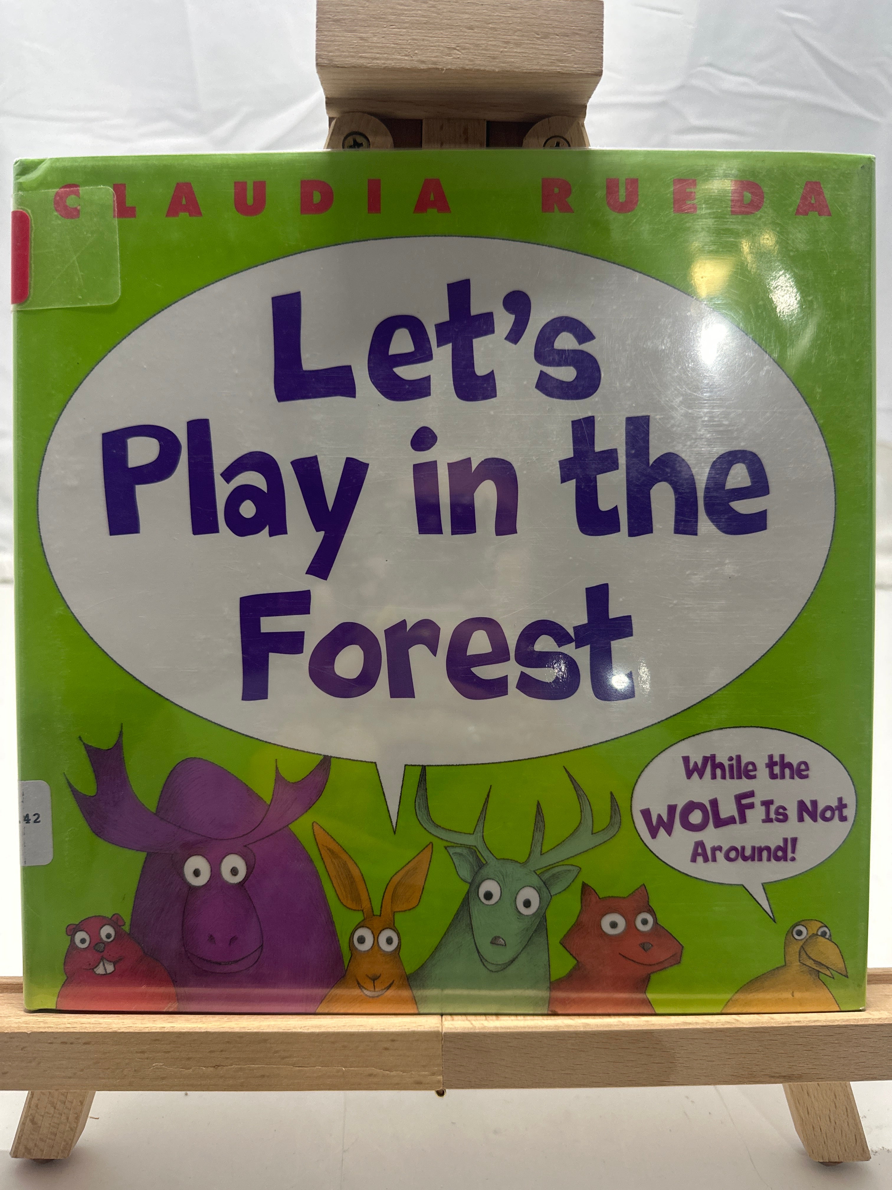 Let's play in the forest while the wolf is not around by Claudia Rueda Hardcover
