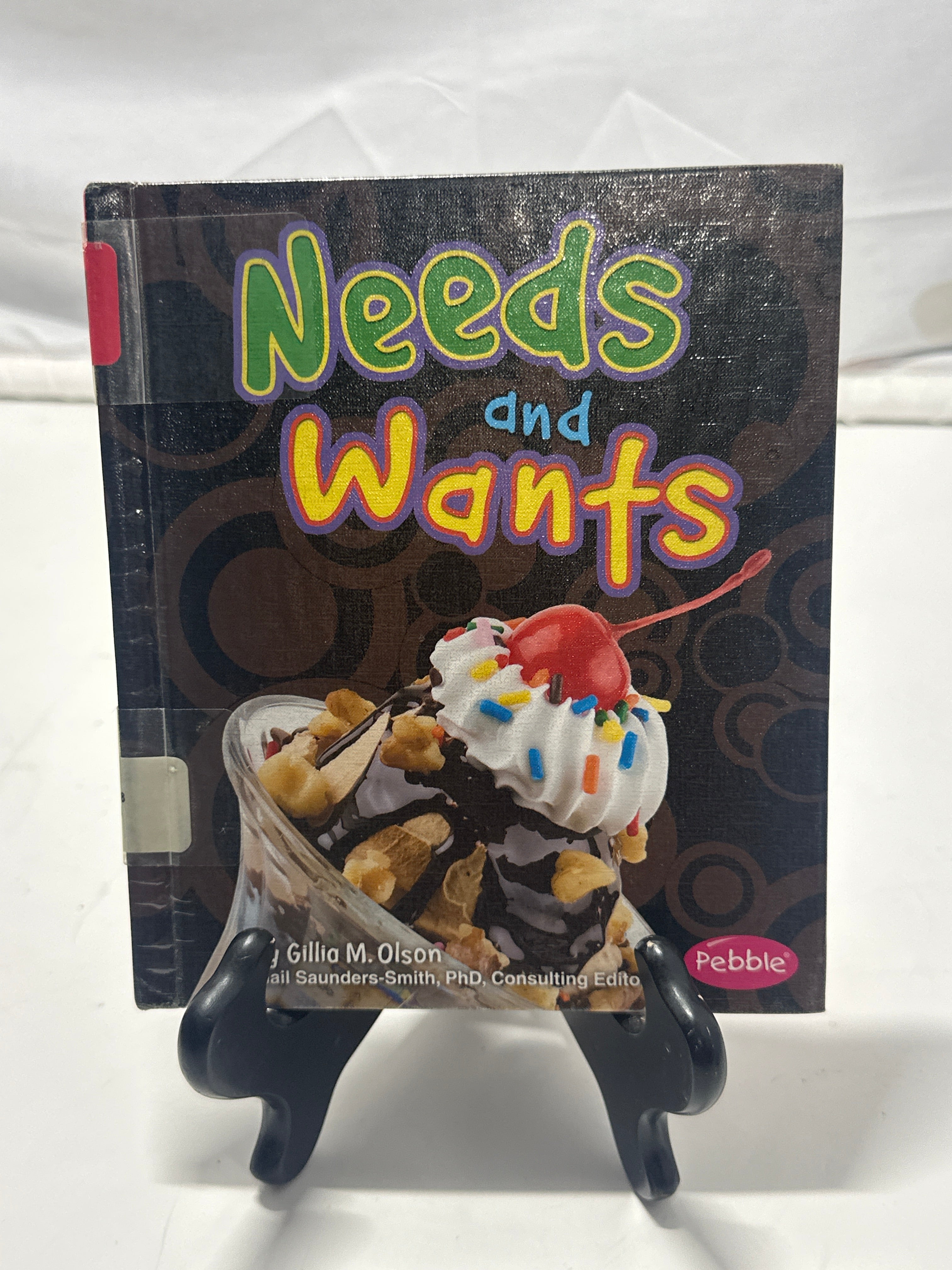 Needs and wants by Gillia M. Olson Hardcover Children's Book
