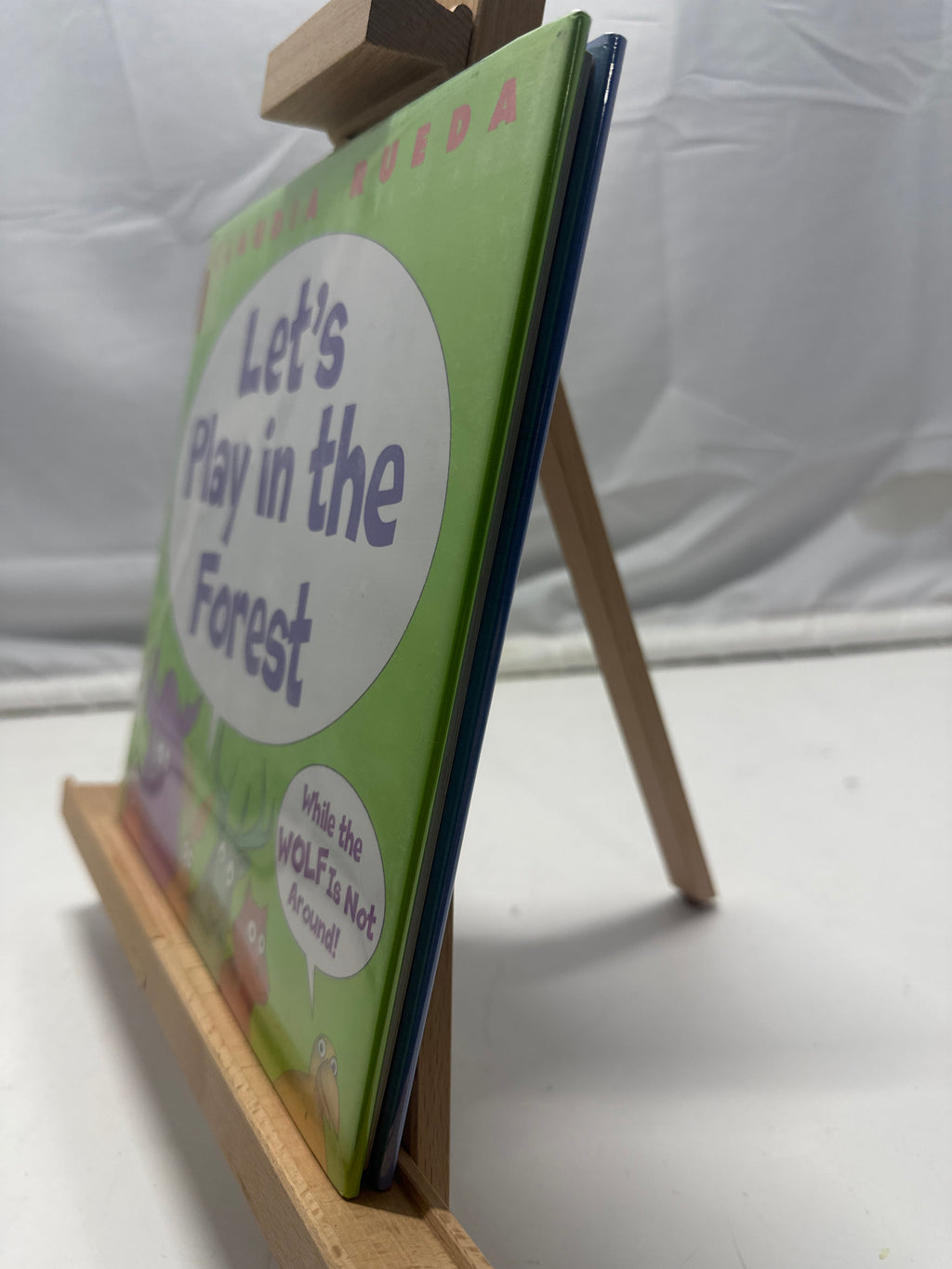 Let's play in the forest while the wolf is not around by Claudia Rueda Hardcover